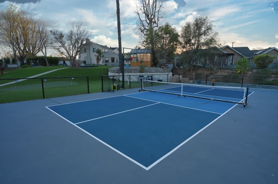 Finished blue recreation court beside a turf field in the TurfMastro gallery