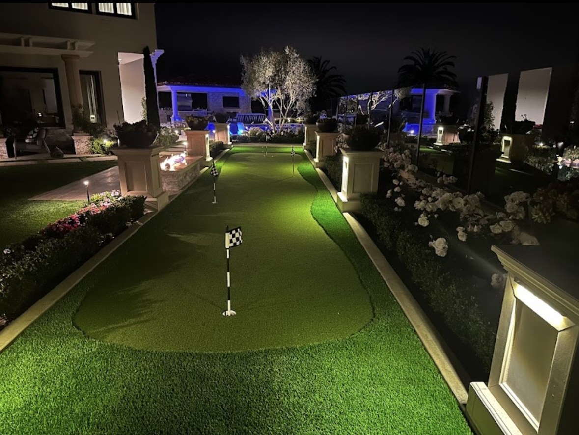 Illuminated backyard putting green at night