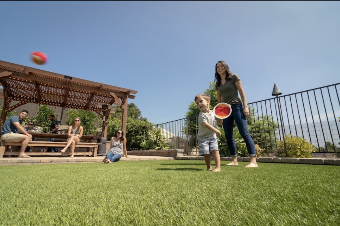 Finished TurfMastro backyard turf lawn used for outdoor family recreation