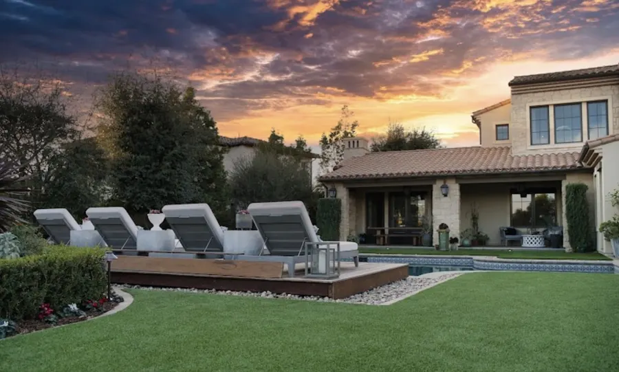 Finished TurfMastro turf lawn beside a pool and outdoor seating