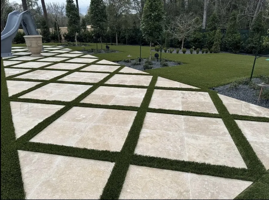Large square pavers divided by turf in a residential yard